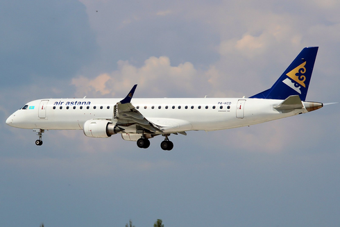 A photo of the small ERJ-190 of Air Astana on a cloudy day in Kazakhstan. 