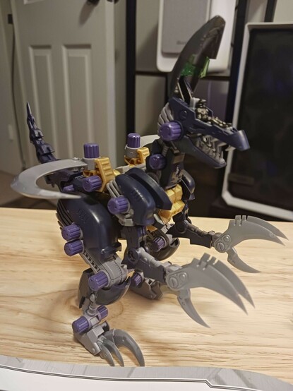 A photograph of the completed raven raptor Sirius, standing in a fairly neutral position with his tail still making the banana curve and the cockpit open, showing the pilot. No idea why I went for that shot specifically, but I'm not actually sure I've shown too many of the models' hatches open before. The pilots give a good sense of scale, I think.