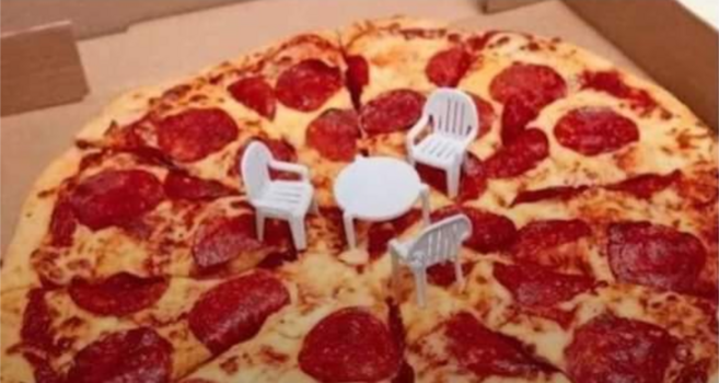 photo of a standard north american pepperoni pizza in a pizza box, with the little white plastic table thingy they put in pizza boxes. there are three small plastic chairs to go around the table.