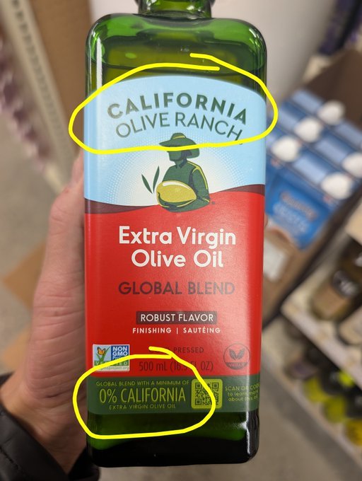 A hand holds a bottle of circled California Olive Ranch Extra Virgin Olive Oil. It is a global blend and the other circle notes it contains 0% California origin oils